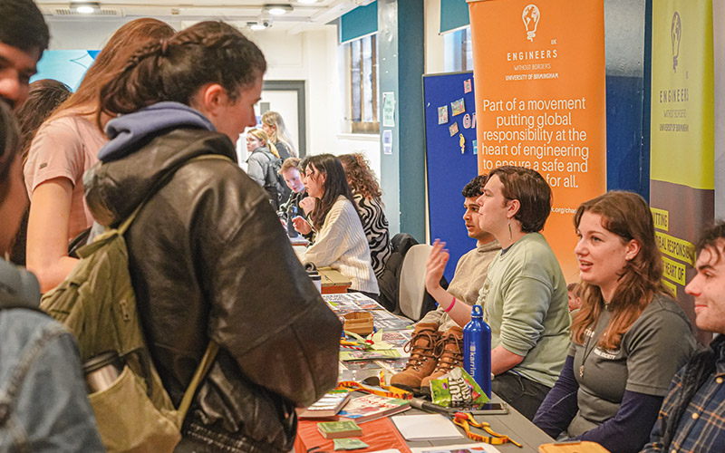 Students at a stand at Refreshers Fair