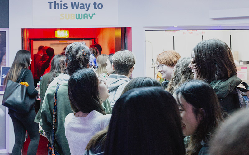 An activation in the retail area with students queing up