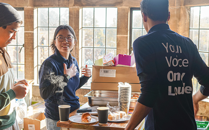 a photo of a student staff members talking to students