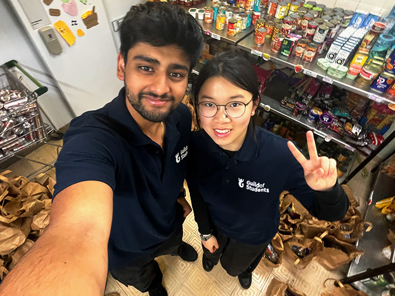 an image of student staff in the pantry surrounded by food
